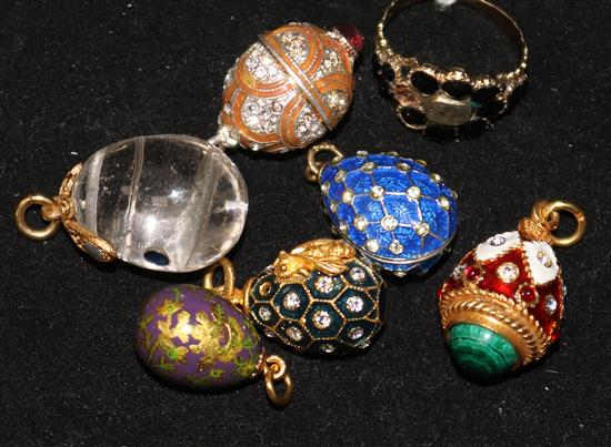 A mid 19th century gold and gem set mourning ring and six assorted egg charms.